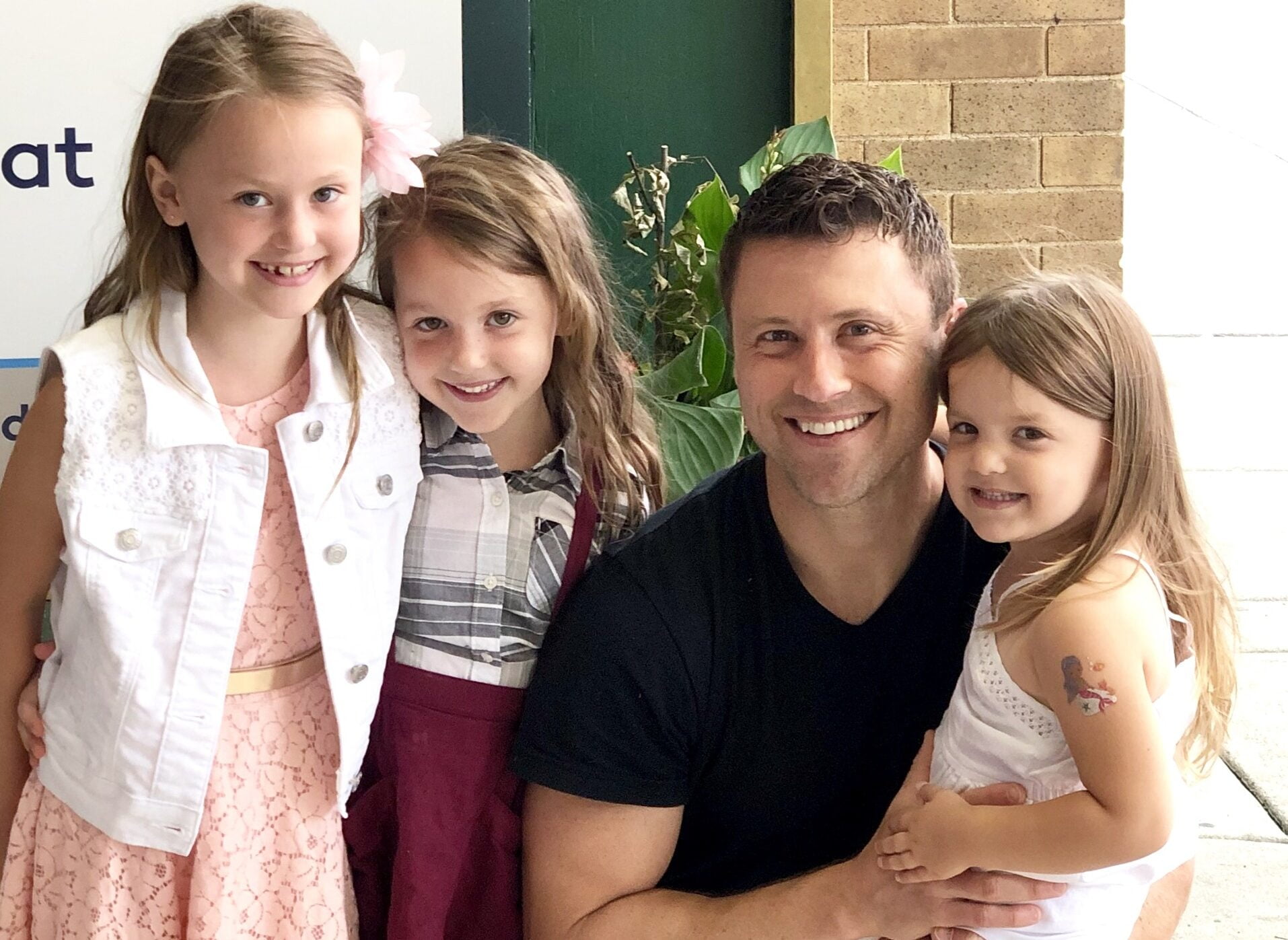 JC Cross with three daughters outside church