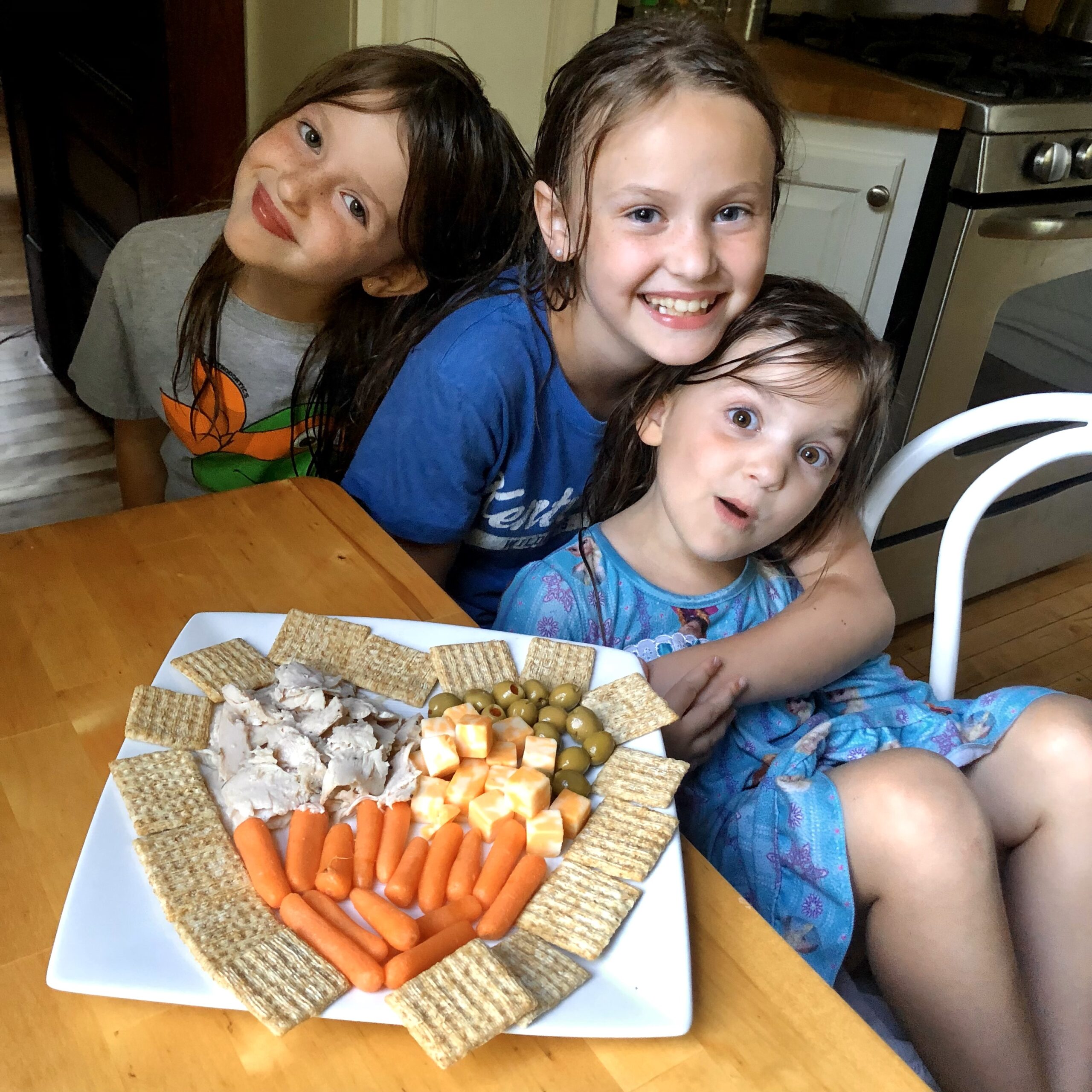 Cross girls enjoying dinner at their father's home after a day at the lake.